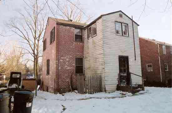 BEFORE: A poorly made, 1950s-era addition was built onto the back of the original brick house.